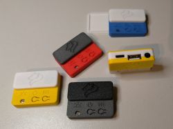 Five colorful DIY music players with buttons, USB, mini-jack ports and fox logo.