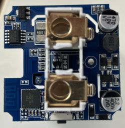 Printed circuit board with electronic components, including capacitors and connectors.