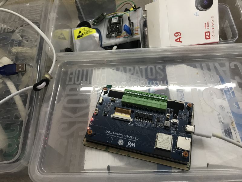 ESP32-S3 Touch LCD-5 development board with green terminal block in a clear plastic storage box