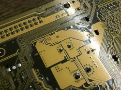 Close-up of a circuit board showing traces and holes.