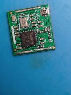 Close-up of a printed circuit board with a microchip and electronic components.