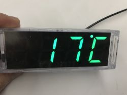 Green 7‑segment display in an acrylic case showing “17°C”