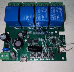 Close-up of an electronic PCB with four blue relays.