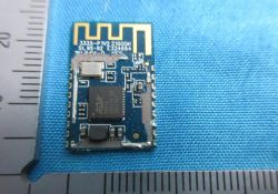 Bluetooth electronic module with RDA chip on blue fabric near a ruler