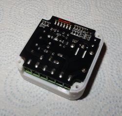 Close-up of the bottom side of a PCB with soldered components and screw terminals