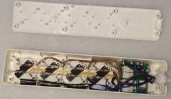 Interior of a Power Strip Open plastic casing of a power strip showing internal electronic components and wiring.