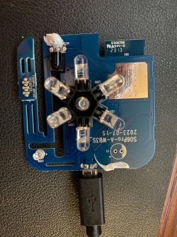 Circuit Board with LEDs and USB Cable A circuit board of an electronic device with several LED lights and a connected USB cable.
