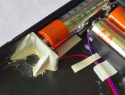 Close-up of battery compartment in DIY radio with three AA batteries installed.