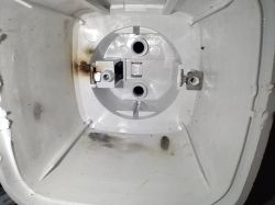 Interior of a plastic electrical junction box with visible burn and scorch marks.