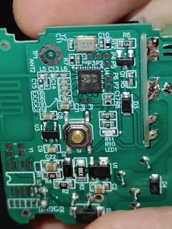 Close-up of a PCB with push button and integrated circuit Close-up of a green PCB with a push button, an IC, and multiple SMD components