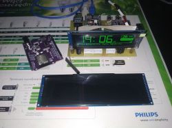 ESP32-S3 kit with OLED display on a desk.