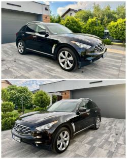 Black Infiniti FX SUV parked on a modern driveway in front of a house.