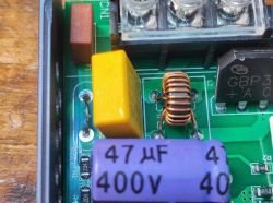 Inside view of LED power supply with coil, rectifier bridge, and 400V capacitor