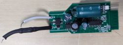 Appio Light Bulb Circuit Board Printed circuit board with electronic components on a wooden background.