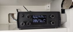 Radio with a display and knobs in a kitchen cabinet