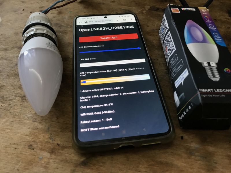 Locally controlled E14 LED bulb with LN882H and OpenBK firmware E14 LED bulb next to a smartphone showing the OpenBK firmware interface and the product box.