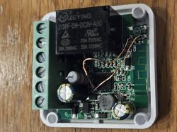 Interior of Mini Smart Switch with Relay The image shows the interior of a Mini Smart Switch with a visible relay and electronic components on a circuit board.
