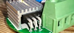 Close-up of electronic components with a heatsink and connector.