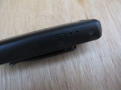 Side view of a portable voice recorder Black clip-on voice recorder with button and two small holes