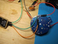 Circuit Board with Wires on a Bench Circuit board with connected wires on a workbench.