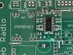 PAM8403 amplifier module on a green PCB next to labeled solder pads for L/R outputs.