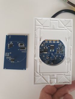Two printed circuit boards with electronic components, one placed in a white frame.