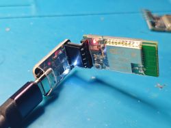 Bluetooth BLE Module Connected to USB Bluetooth BLE module connected to a USB adapter on a blue background.