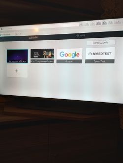 Television displaying a browser with bookmarks for HBO Max, Megogo, Google, and Speedtest.