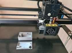 3D Printing a Case for an Electronic Device 3D printer printing a case for an electronic device.