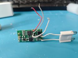Electronic Circuit Board with BK7231N Module Electronic circuit board with integrated circuit and connected wires on a blue background
