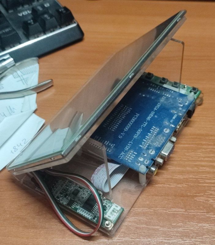 Electronic kit with display and circuit board on a desk.