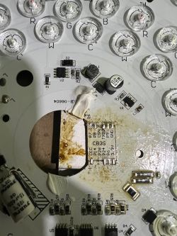 Close-up of the inside of a lighting module with a visible PCB and electronic components, such as a capacitor, LEDs, and a CB3S chip.