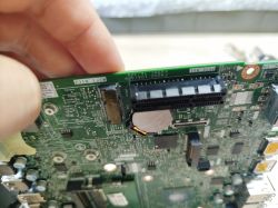 Motherboard with PCI slot and soldered components.