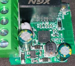 Close-up of a green printed circuit board with various electronic components.