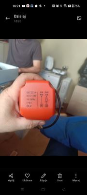 Orange actuator labeled “SKT2014” held in a hand, with a cable visible