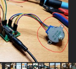 28BYJ-48 stepper motor connected to microcontroller board on wooden surface