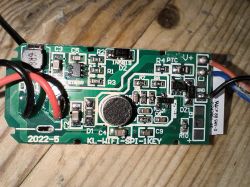 Circuit board with electronic components View of a circuit board with electronic components, mainly resistors, capacitors, and a microphone.