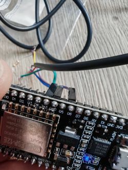 NodeMCU ESP8266 with DS18B20 Temperature Sensor Connected Close-up of a NodeMCU v2 ESP8266 module with attached wires and a connected DS18B20 temperature sensor.