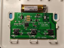 Printed circuit board with three buttons, 12V battery, and electronic components