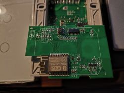 Close-up of a green printed circuit board (PCB) with a WiFi module and electronic components.