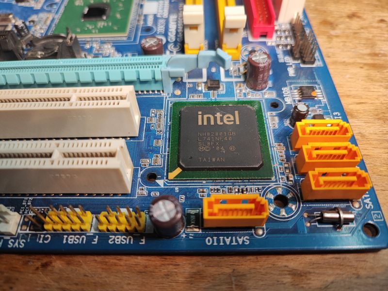 Old Intel Motherboard with Visible Components Close-up of an old Intel motherboard with visible connectors and components.