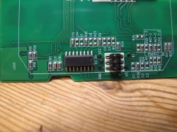 Close-up of a Circuit Board with Electronic Components Close-up of a circuit board with visible traces, resistors, and a connector.