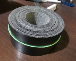 Roll of thick black thermal adhesive veneer with textured underside