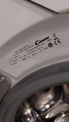 Candy CS3 1052D2-S - jak dostać się między bęben, a obudowę?