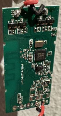 Close-up of a green printed circuit board with electronic components.