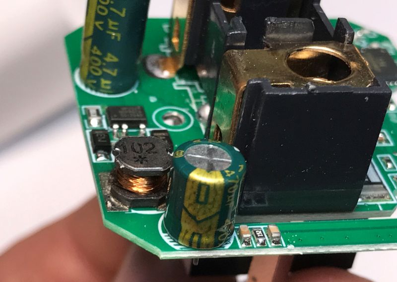 Close-up of a Printed Circuit Board with Electronic Components Close-up of a green printed circuit board with various electronic components such as capacitors and coils.