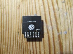 ESP-C2 module on a wooden surface