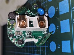 Close-up of a PCB with capacitors, coils, and large copper contacts