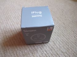 Sonoff S60TPG iPlug Type G Box Gray box of Sonoff S60TPG iPlug Type G smart plug on a beige carpet.