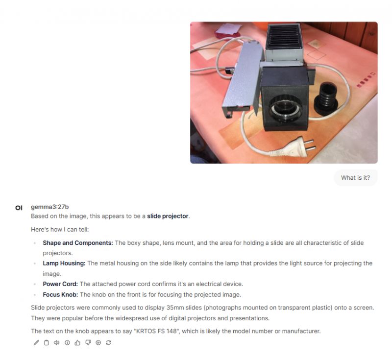 Slide Projector with Accessories The image shows a slide projector with accessories on a table.